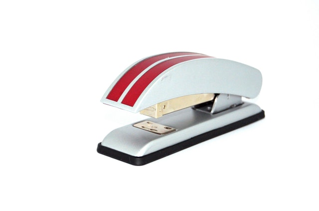 red and white stapler